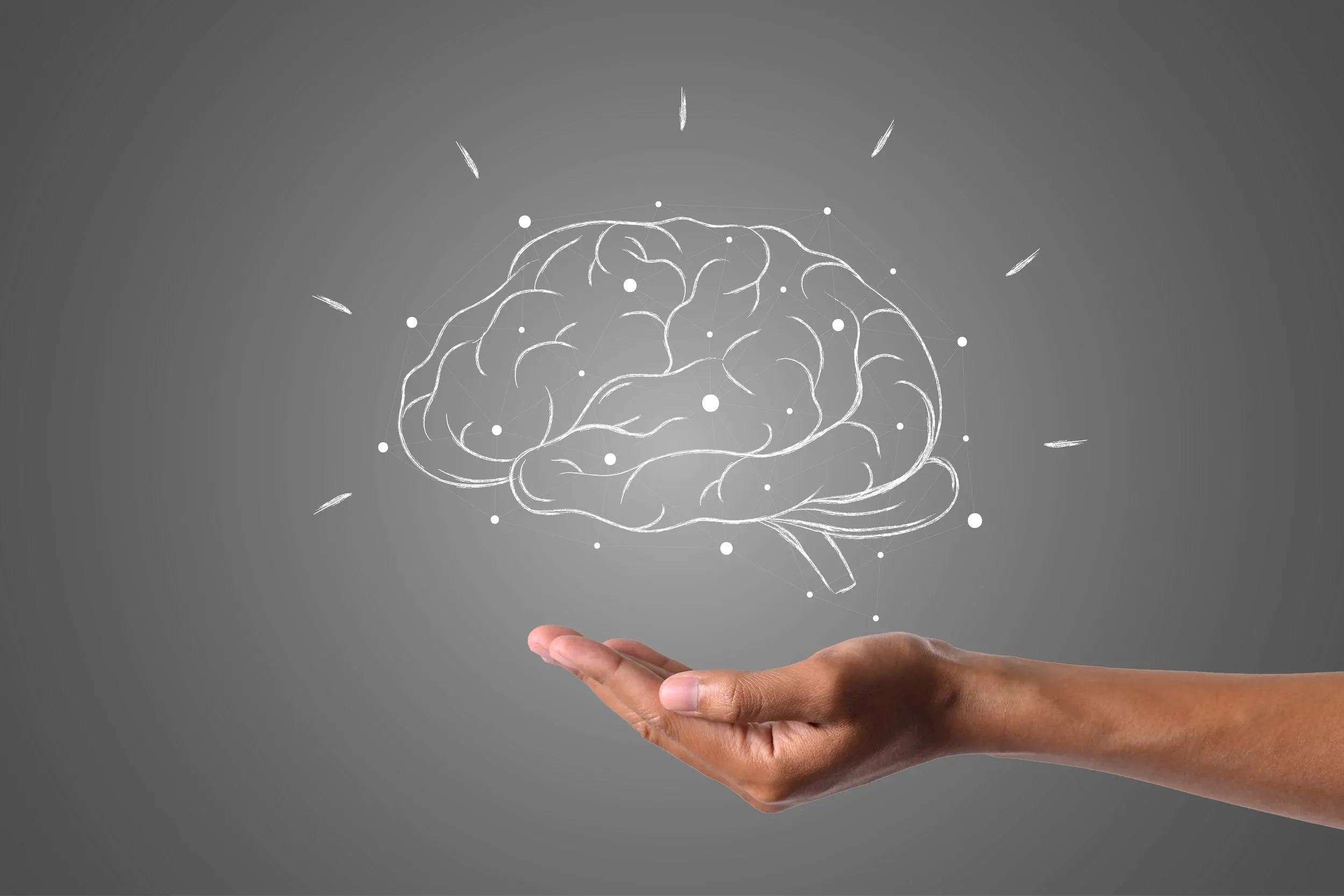 An illustrated brain floating above an open hand