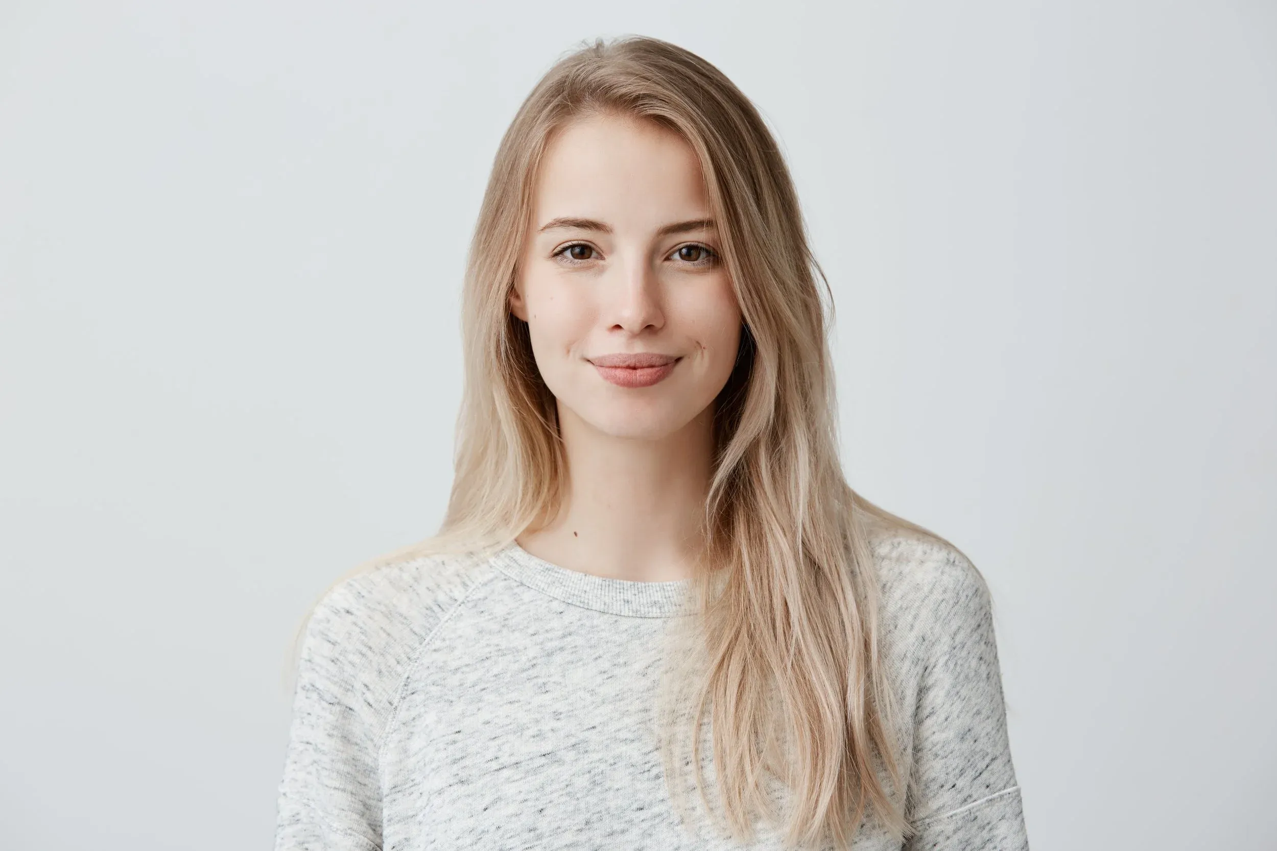A calm woman smiling toward the camera